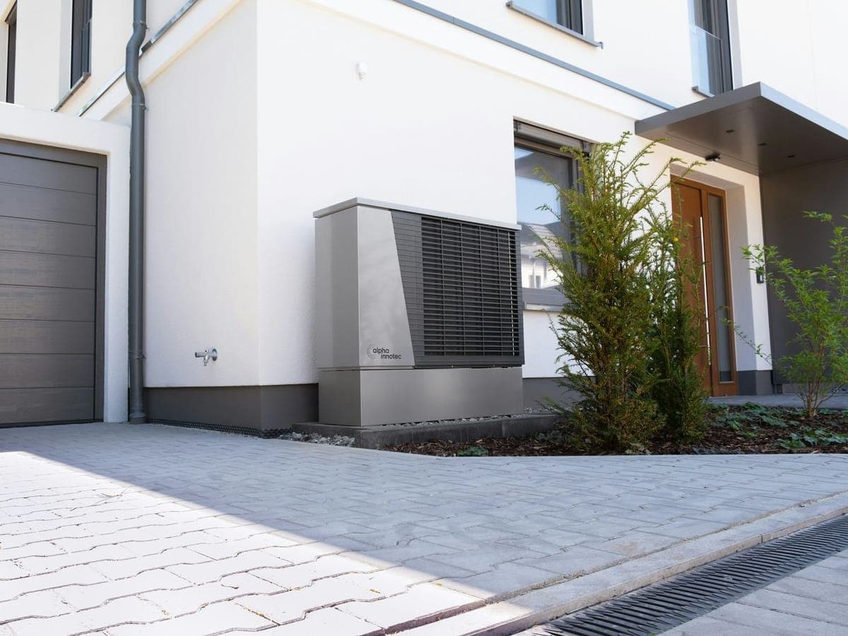 Pompe à chaleur air/eau installée en pignon d’une maison individuelle.